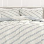 Striped bedding set on bed.