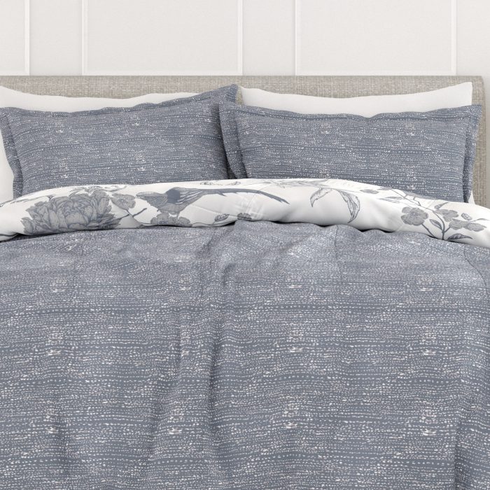 Gray and white floral bedding set on bed