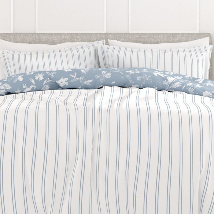 Striped bed linens with floral duvet cover.