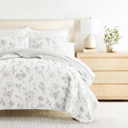 Floral bedding on modern bedroom furniture setup.